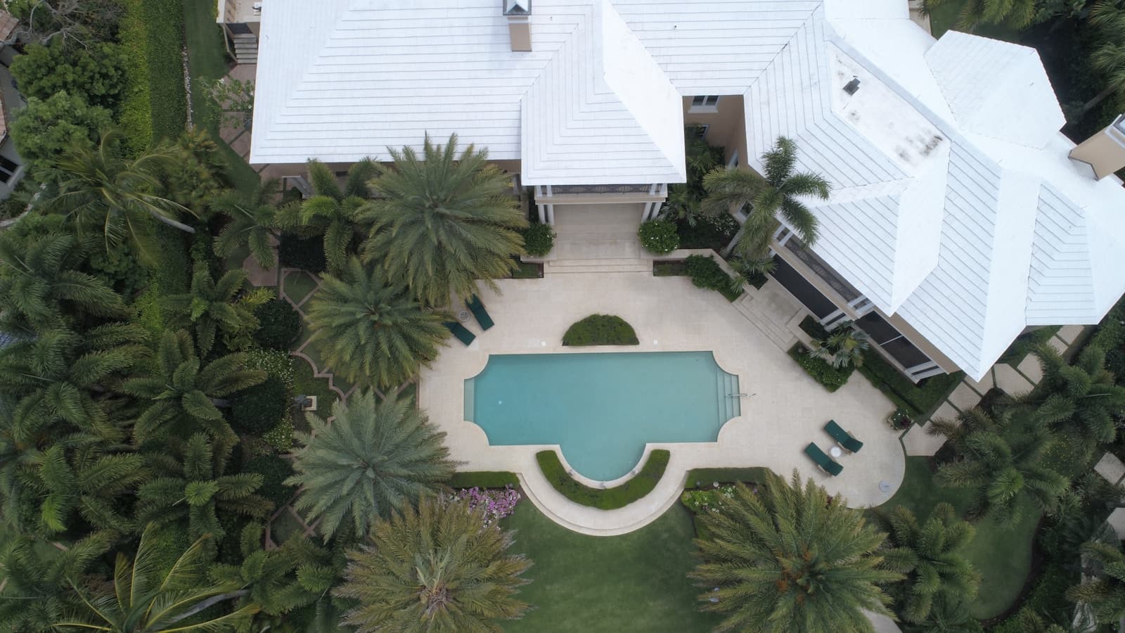 Aerial view of home with paver patio and pool